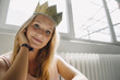 © Westend61 - Portrait of blond young woman wearing a crown