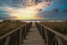 Wooden Path And Sunset On The Beach Of El Palmar, Near The Caños De Meca, An Ideal Place To Spend A Great Holiday On The Coast Of The Province Of Cadiz, In Andalusia, Spain