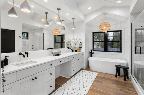 Cuadros en Lienzo Beautiful bathroom in luxury home with double vanity, bathtub, mirror, sinks, sh
