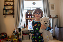 Portrait Cute Boy In Pajamas With Teddy Bear Showing Drawing On Smart Phone