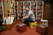 Portrait Of Man Organizing Records In Independent Record Store