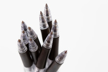 Closeup Ten Black Ballpoint Pens On White Background