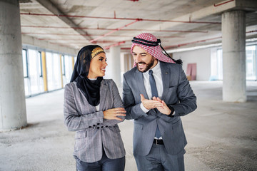 Wall Mural - Satisfied muslim investors standing in building in construction process and talking about price for that place. Money is never a problem if plan they have is going well.