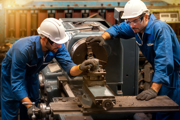 Wall Mural - Technicians and engineers are working on machines in a factory. Twins Caucasian man Mechanical Engineer checking equipment in the industrial.