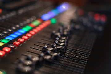 Buttons of professsional music audio sound mixer. Low DOF, selective focus.