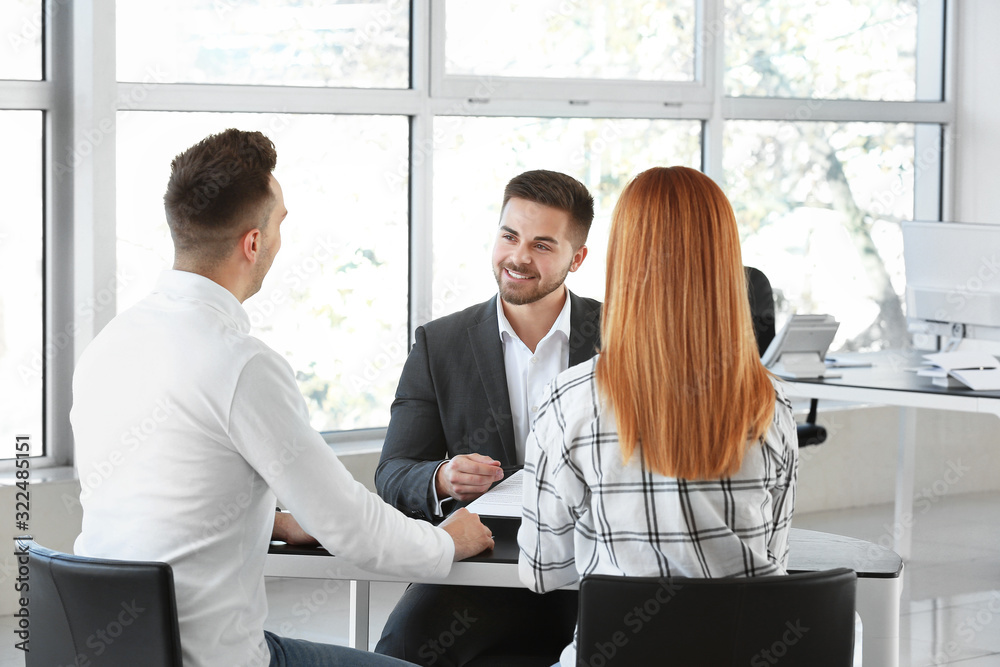Bank manager working with clients in office