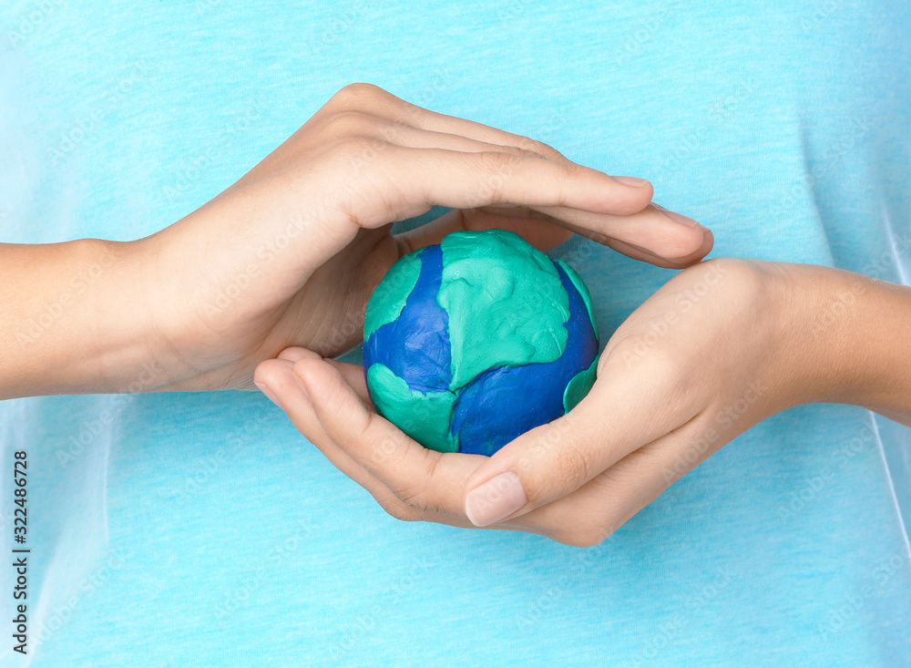 Woman with model of Earth on white background, closeup
