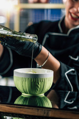 Wall Mural - Chef Pouring Olive Oil into a Fresh Green Salad