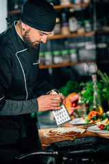 Wall Mural - Preparing Vegetarian Burrito - Chef Grating Cheese with a Grater