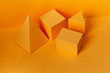 © besjunior - Yellow geometrical figures still life composition. Three-dimensional prism pyramid rectangular cube objects on yellow background. Platonic solids figures, simplicity concept