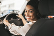 © Prostock-studio - Happy African American Woman Sitting In Auto In Dealership Center