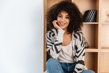 Poster - Optimistic beautiful young african woman indoors at home.