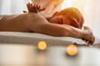 Sports massage. Massage therapist massaging shoulders of a male athlete, working with Trapezius muscle. Toned image. Masseur doing massage on man body in the spa salon. Beauty treatment concept.