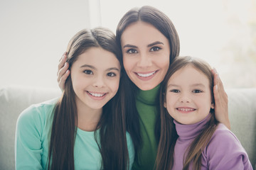 Sticker - Close up photo of cheerful charming mother with two cute children cuddle enjoy spend free time together in living room