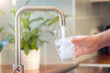 canvas print picture - Filling up a glass with drinking water from kitchen tap