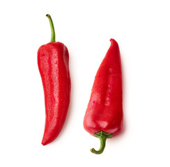 Two whole red bell peppers isolated on white background