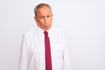 Canvas Print - Senior grey-haired businessman wearing elegant tie over isolated white background skeptic and nervous, frowning upset because of problem. Negative person.