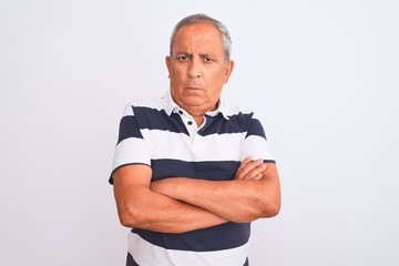 Wall Mural - Senior grey-haired man wearing casual striped polo standing over isolated white background skeptic and nervous, disapproving expression on face with crossed arms. Negative person.