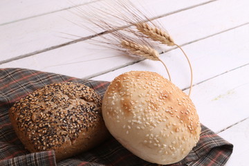 delicious bread rolls on colored background