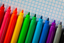 Image of opened multicolored markers on notepad
