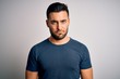 © Krakenimages.com - Young handsome man wearing casual t-shirt standing over isolated white background depressed and worry for distress, crying angry and afraid. Sad expression.