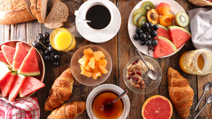 Wall Mural - full breakfast with coffee cup, tea cup, croissant, bread and fruit