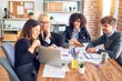 © Krakenimages.com - Group of business workers smiling happy and confident. Working together with smile on face  using laptop and speaking at the office