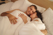 © Space_Cat - Young adult couple sleeping on the bed in bedroom