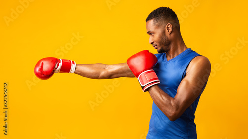 Leinwand Poster Portrait of confident black man wearing red gloves