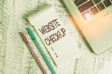 Fototapete - Text sign showing Website Check Up. Business photo text an examination of a website to see if something is in order Trendy laptop blank ruled notepad pens lying wooden rustic vintage table