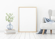 © marina_dikh - Poster mockup with vertical frame standing on floor in living room interior with armchair and branches in blue vase on empty white wall background. 3D rendering, illustration.