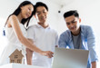 © ronnachaipark - Asian couple Decide to buy a new house from laptop with Real estate agent, subject is a house model with key