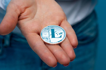 An Unidentified Young Woman Holds A Litecoin