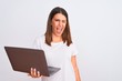 © Krakenimages.com - Beautiful young woman working using computer laptop over white background winking looking at the camera with sexy expression, cheerful and happy face.