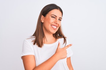 Poster - Portrait of beautiful and young brunette woman standing over isolated white background cheerful with a smile of face pointing with hand and finger up to the side with happy and natural expression