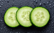 Isolated Cucumber Slices. Pieces Of Fresh Cucumber Isolated On Black Background