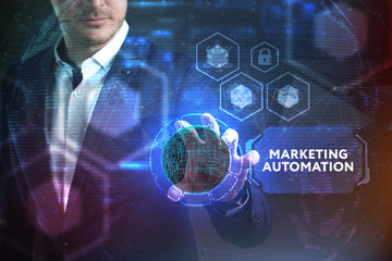 Business, Technology, Internet and network concept. Young businessman working on a virtual screen of the future and sees the inscription: Marketing automation