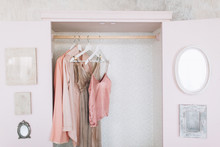 Wooden Pink Wardrobe For Women’s Clothes, Open Doors, Decor, Mirror, Bag, Hangers, Silk Dresses In A Bright Room, Concept, Flowers Delicate Pastel Colors