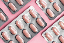 White Blister Pack Of Tablets Pill Statins For Light Resistance Packaging On Pink Background. Pink Tablets