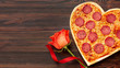 Lovely arrangement for valentines day dinner with heart shaped pizza and rose