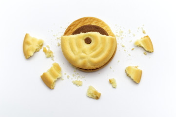 Sticker - Sandwich cookies filled with coffee cream flavored. Some broken and crumbs of crunchy delicious sweet meal and useful cookie on white background.