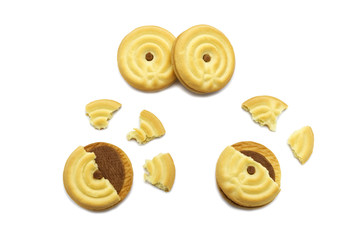 Wall Mural - Sandwich cookies filled with coffee cream flavored. Some broken and crumbs of crunchy delicious sweet meal and useful cookie isolated on white background.