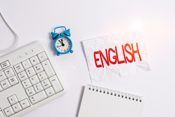 Poster - Conceptual hand writing showing English. Concept meaning Related to England showing language culture British Literature class Paper with copy space on table with clock and keyboard