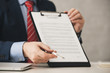 © LIGHTFIELD STUDIOS - cropped view of agent holding clipboard with contract lettering and pen