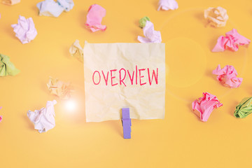 Poster - Writing note showing Overview. Business concept for the general review or summary of subject project movie book Colored crumpled paper empty reminder white floor clothespin