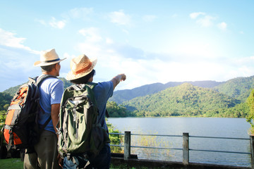 senior asian couple trekking, traveling, living a happy life in retirement healthy, can see the fres
