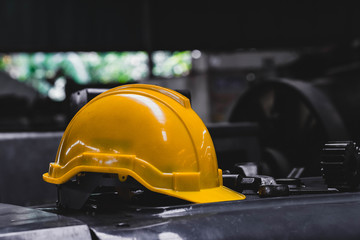 yellow hard safety helmet hat and dark background. engineer, construction and safety concept. copy s