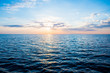 Panoramic view of the Baltic sea at sunset. Latvia. Clear sky, glowing clouds, reflections on water. Blue, pink, orange colors. Nature, seasons, travel destinations, cruise. Idyllic seascape