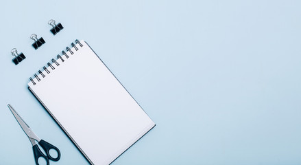 Wall Mural - Office supplies in blue background. Flat lay, top view