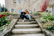 © Cavan Images - Young women using their smartphone sitted on stairs in a french town